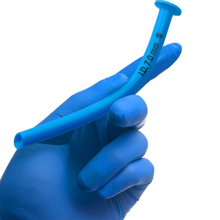 A hand wearing a blue medical glove holding the blue Nasopharyngeal Airway. The image demonstrates the device's size, curve, and flexibility relative to a human hand.