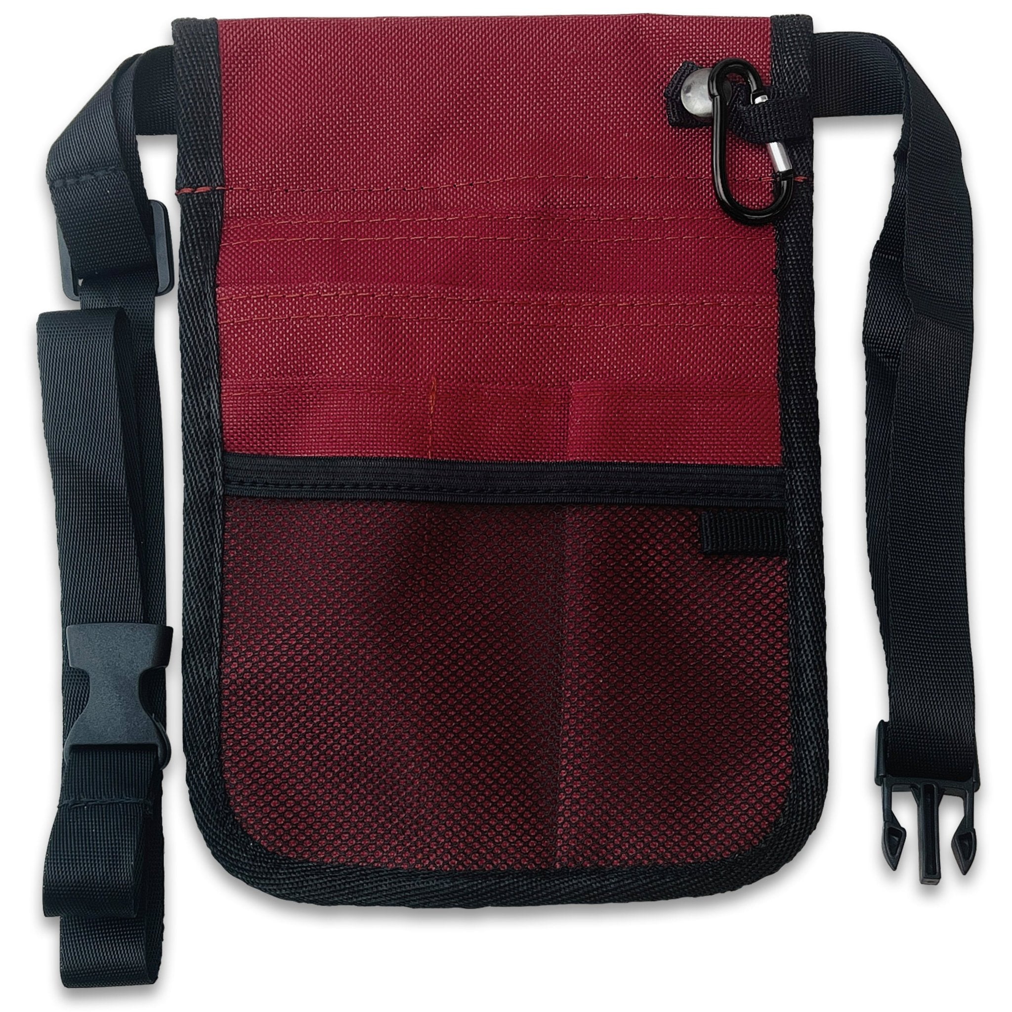 A direct front view of the burgundy nurse fanny pack. It features multiple storage options including a lower mesh pocket, several slip pockets for pens or tools, and a metal carabiner clip attached to the top right. A black adjustable waist strap with a plastic buckle is attached to the sides.