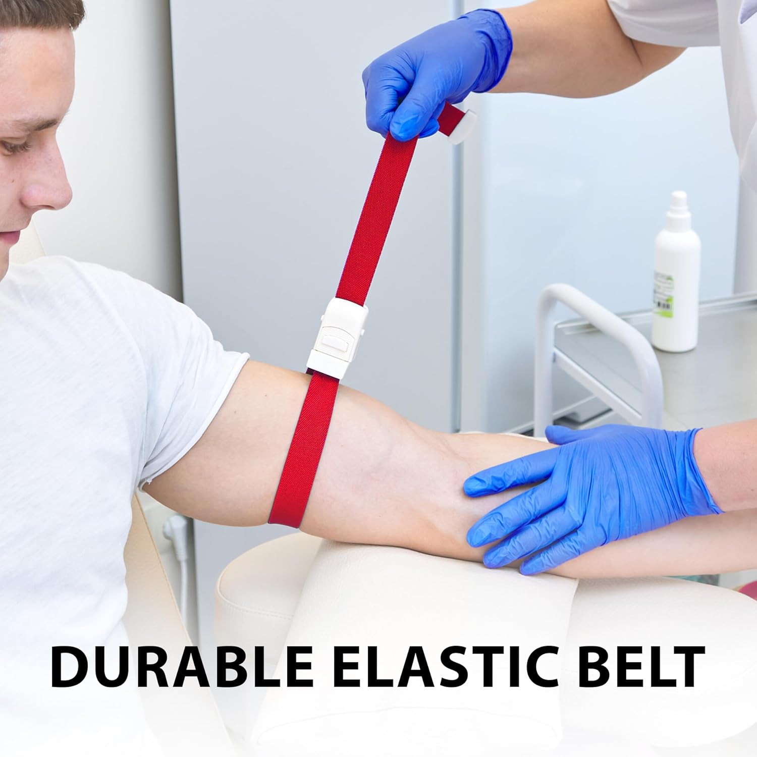 A medical professional wearing blue latex gloves stretching a red tourniquet strap to tighten it around a patient's arm. The image features the text overlay: "DURABLE ELASTIC BELT."