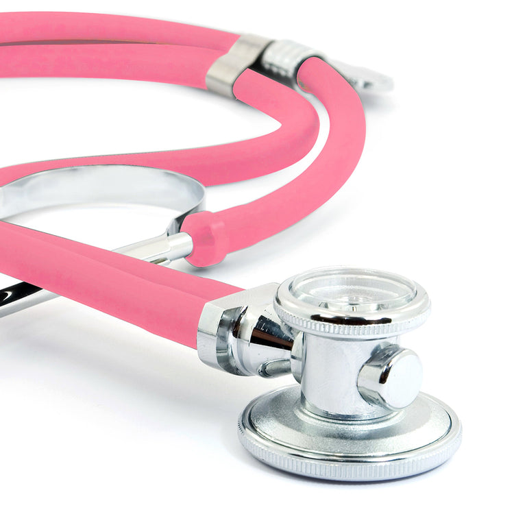 A macro close-up focusing on the rotatable chrome chest piece of the frosted pink stethoscope. It clearly shows the diaphragm side used for high-frequency sounds and the bell side used for low-frequency sounds.