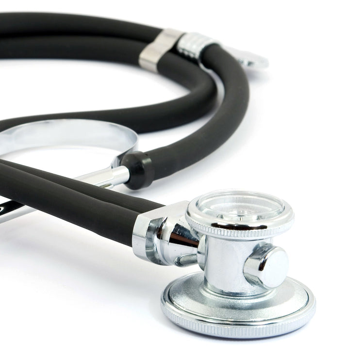 A macro close-up focusing on the rotatable chrome chest piece of the black stethoscope. It clearly shows the diaphragm side used for high-frequency sounds and the bell side used for low-frequency sounds.