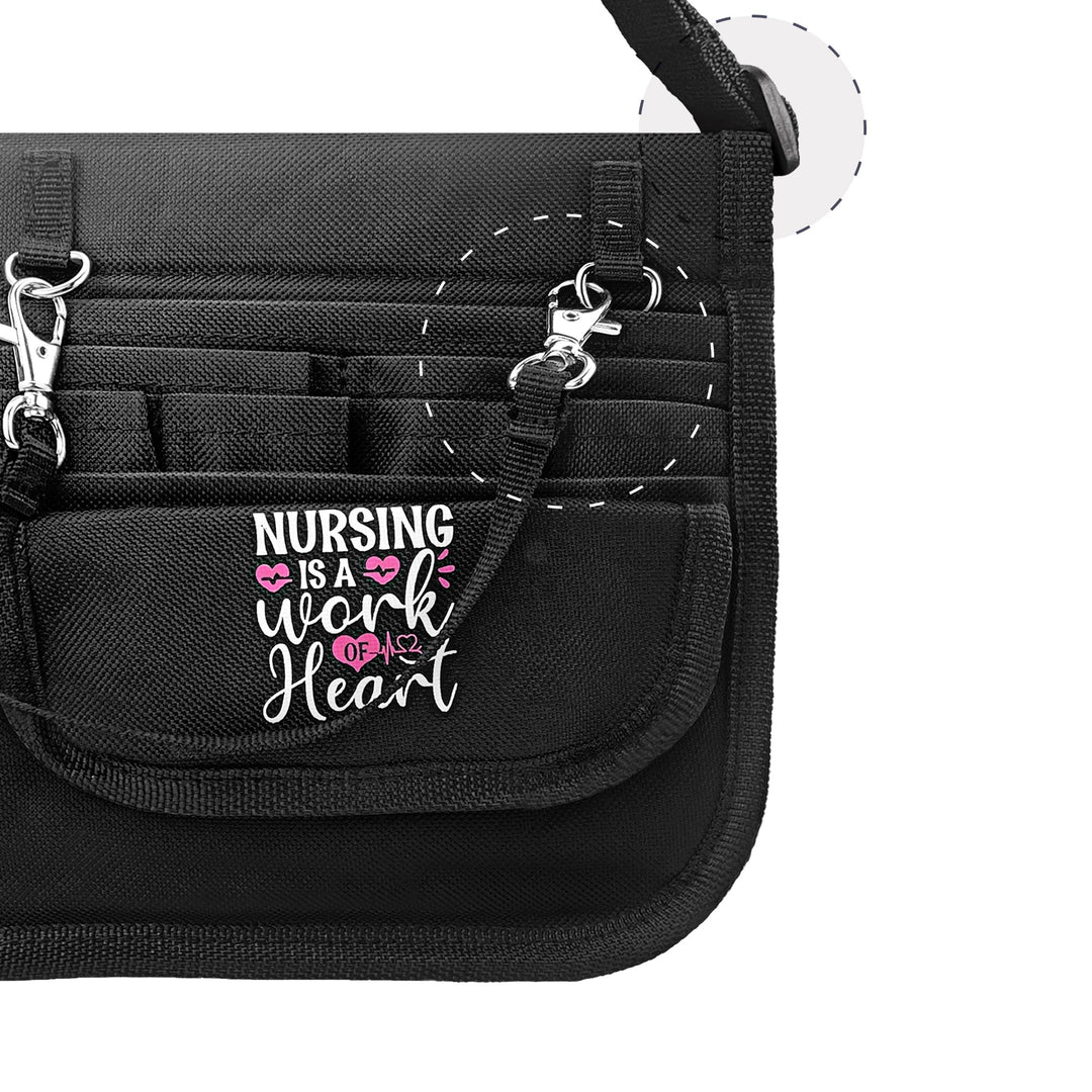 Close-up detail of the front flap featuring the inspiring text 'NURSING IS A WORK OF HEART' in pink and white, alongside a metal accessory clip.