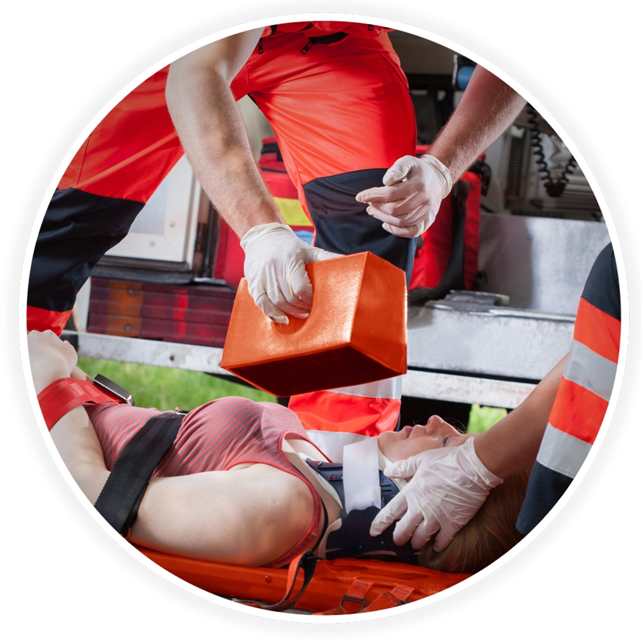 Emergency medical responders in action securing a patient to the spine board using head immobilizer blocks and straps during a rescue.