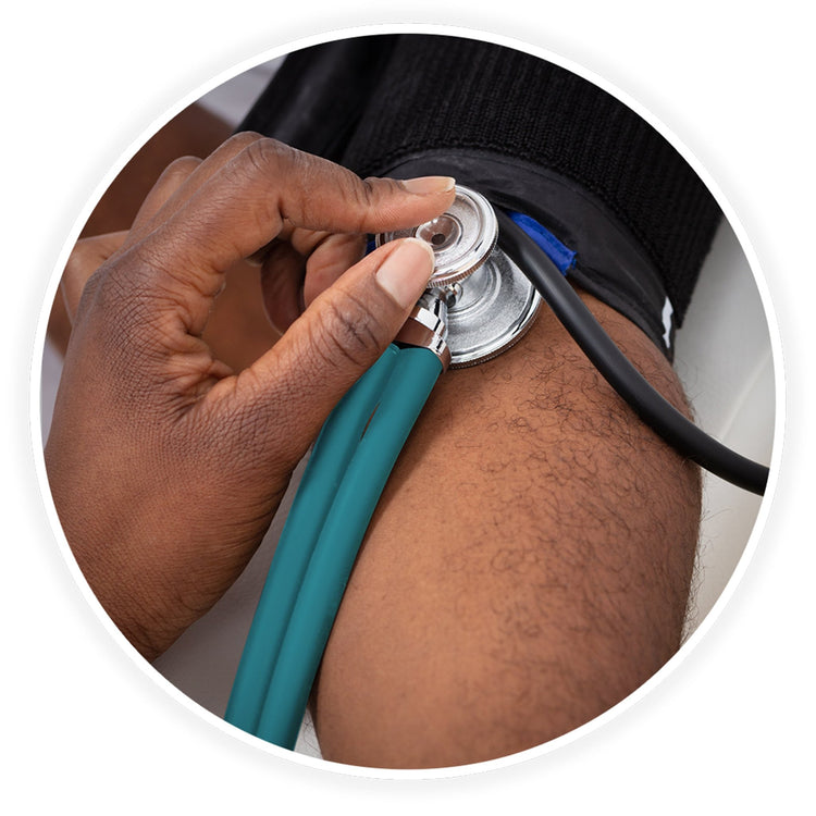 A close-up photo demonstrating a medical examination. A dark-skinned healthcare professional's hand is shown using the teal stethoscope to check a patient's blood pressure, placing the chest piece against the arm just below a black blood pressure cuff.