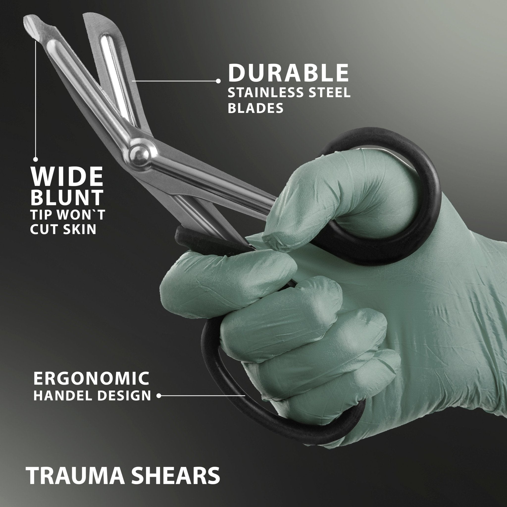 A close-up shot of a gloved hand holding a pair of metal trauma shears against a dark grey background. White lines and text highlight three key features: the "Wide blunt tip won't cut skin" located at the bottom of the blade, "Durable stainless steel blades," and the black plastic "Ergonomic handel [sic] design."