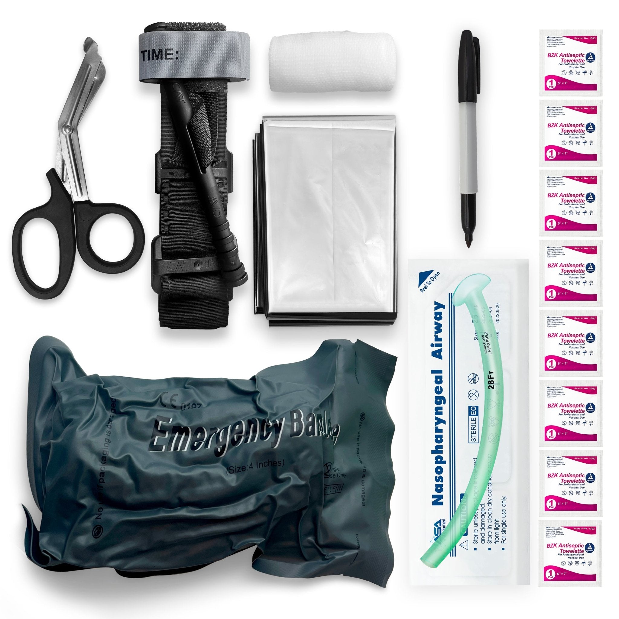 A flat lay photograph of a first aid kit's components arranged on a white background. The items include black trauma shears, a black combat tourniquet, a roll of white gauze, a folded silver emergency blanket, a black marker pen, a packaged nasopharyngeal airway, a grey vacuum-sealed emergency bandage, and eight small packets of BZK antiseptic towelettes.
