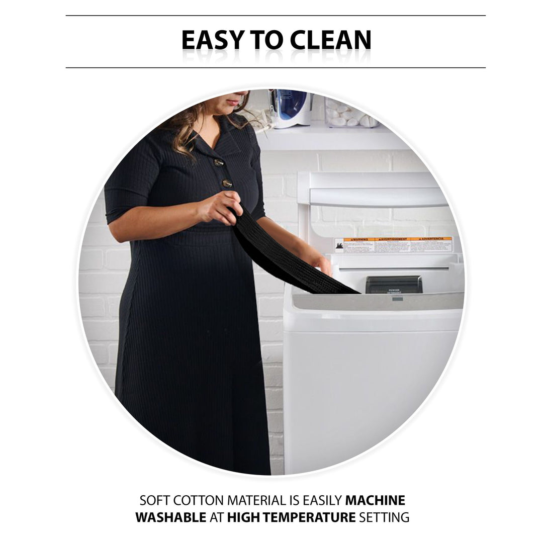 An instructional lifestyle image titled "EASY TO CLEAN." A woman is shown standing in a laundry room, placing the black gait belt into a white top-loading washing machine. Text at the bottom highlights the care instructions: "SOFT COTTON MATERIAL IS EASILY MACHINE WASHABLE AT HIGH TEMPERATURE SETTING."