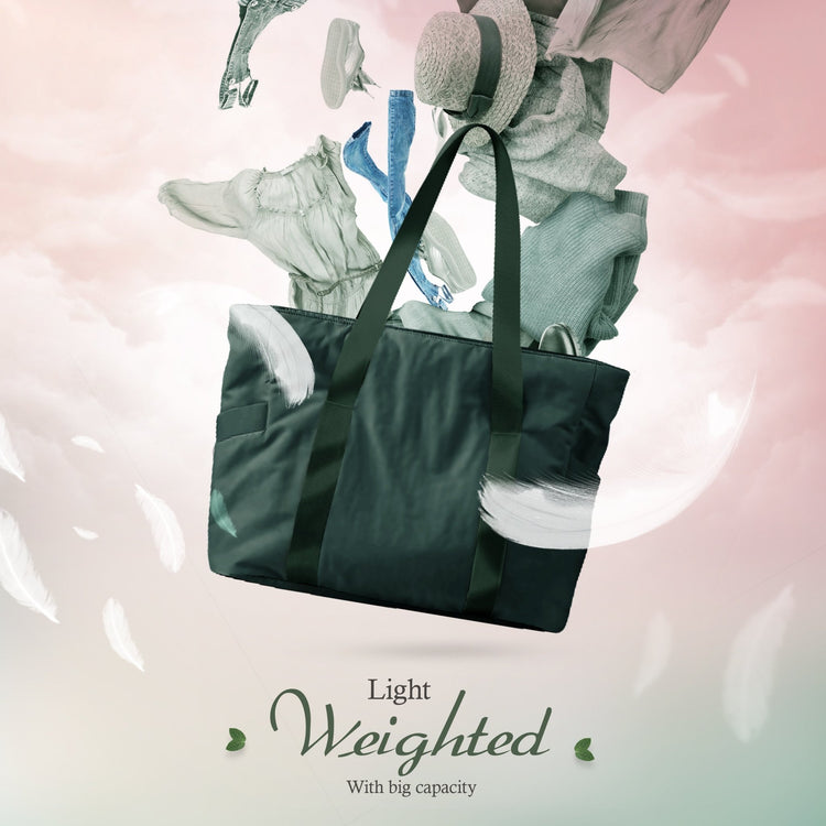 A creative composite image showing the dark green tote bag floating among clouds and white feathers. Various clothing items, including jeans, a hat, and a dress, appear to be floating out of the bag, illustrating its storage potential. Text reads, "Light Weighted With big capacity."